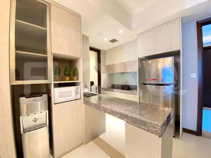 A modern kitchen with a countertop, cabinets, and appliances.