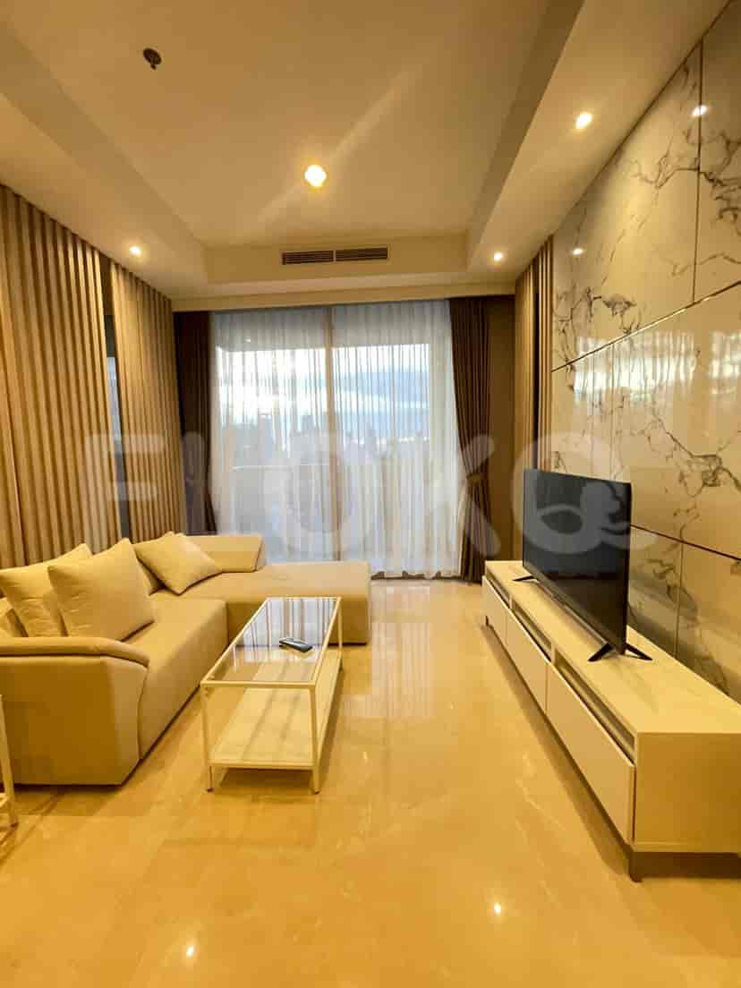 A bright and airy living room featuring a large sofa, smart TV, and views.