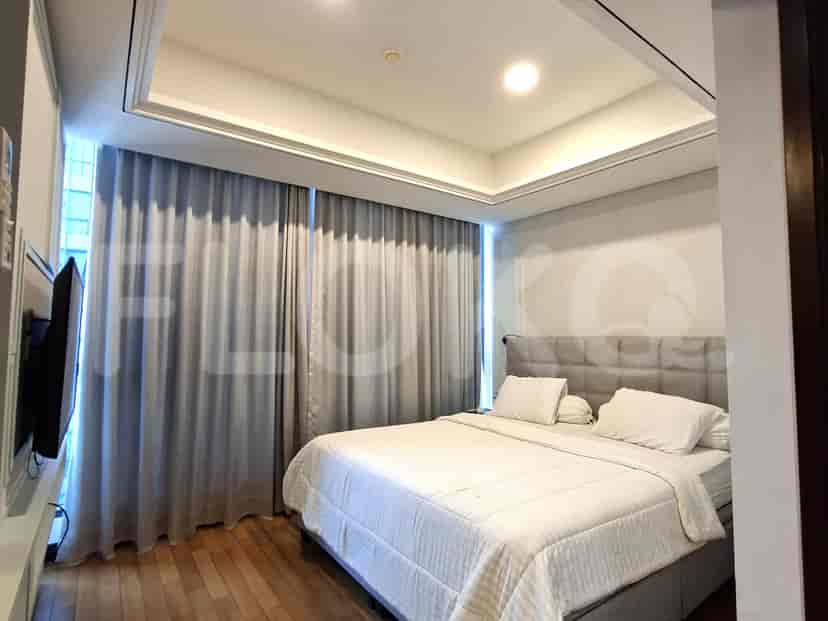 A bright, modern bedroom with a queen bed, a large window, and light-colored curtains.