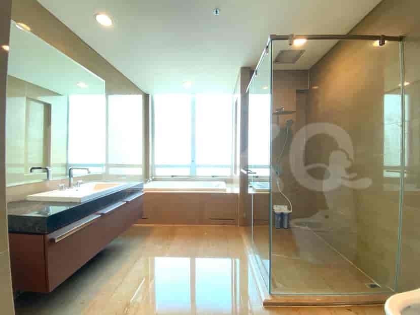 Luxurious bathroom featuring a large mirror, bathtub, and a walk-in shower.