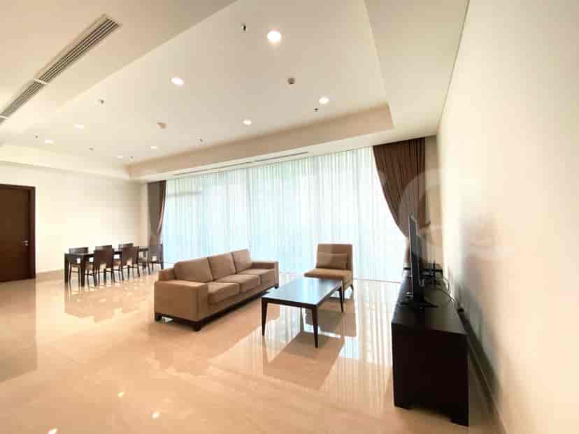 Spacious living area with a brown sofa, a coffee table, and a dining table set for six.