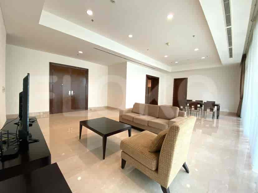 Another view of the living room featuring a sofa, coffee table, and a dining area.