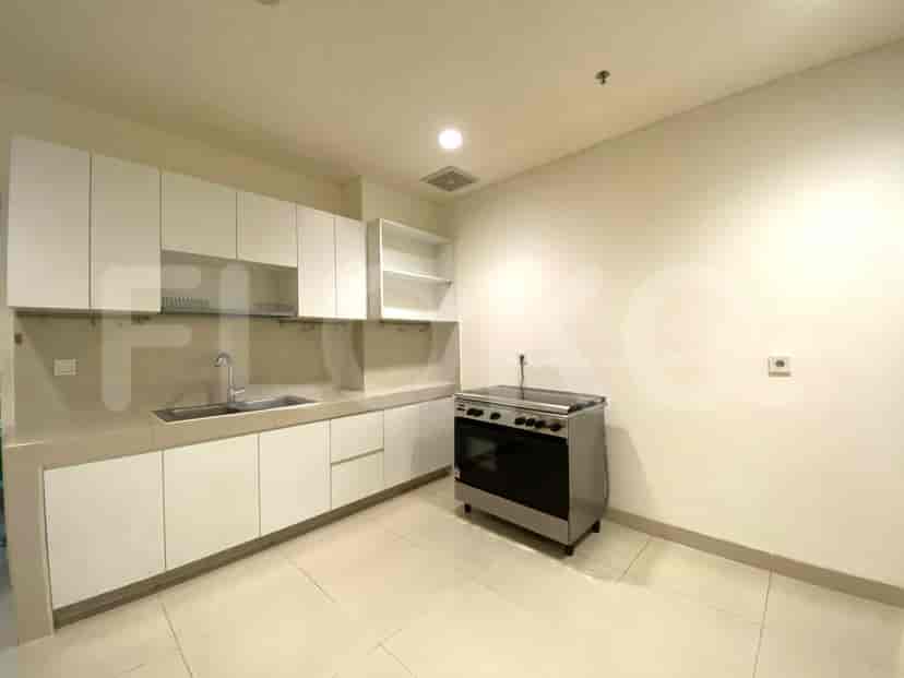 Small secondary kitchen with cabinets and a stove.
