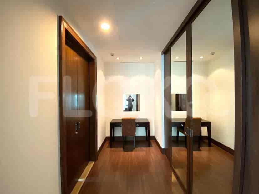 Hallway featuring a mirror, and two desks.