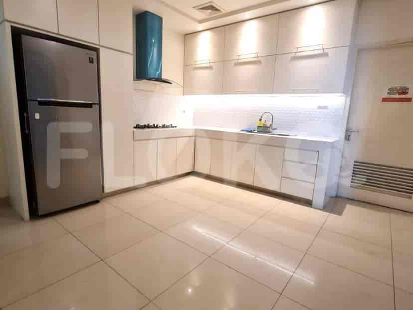 A modern kitchen with white cabinets and appliances.