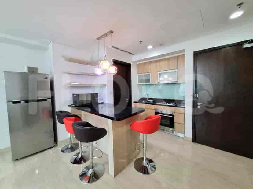The kitchen area with island seating and kitchen appliances.