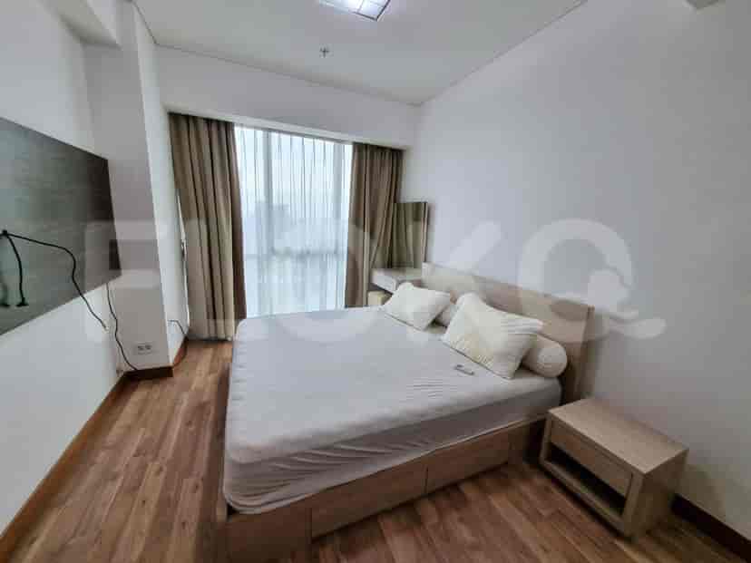 A master bedroom with a bed and window.