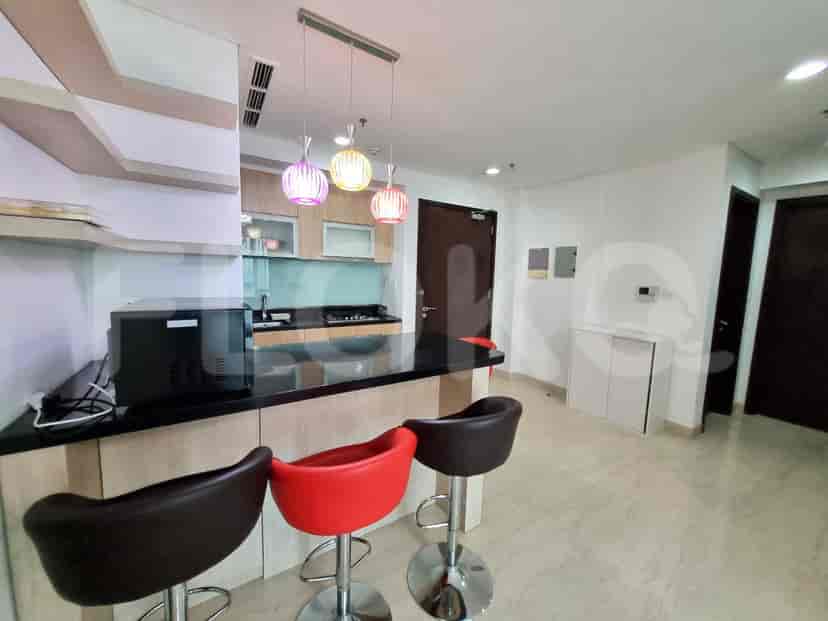 The kitchen area with island seating and kitchen appliances.