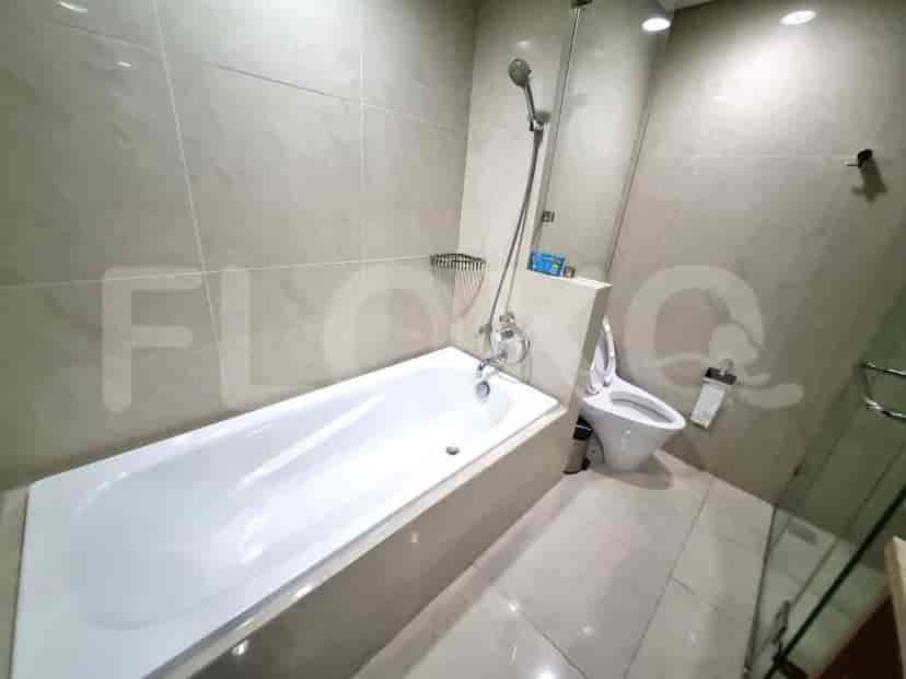 A modern bathroom featuring a bathtub and shower area.
