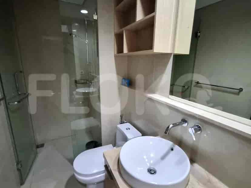A modern bathroom with a sink and enclosed shower.