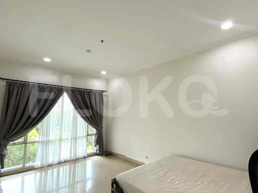 A bedroom with a bed and curtains.