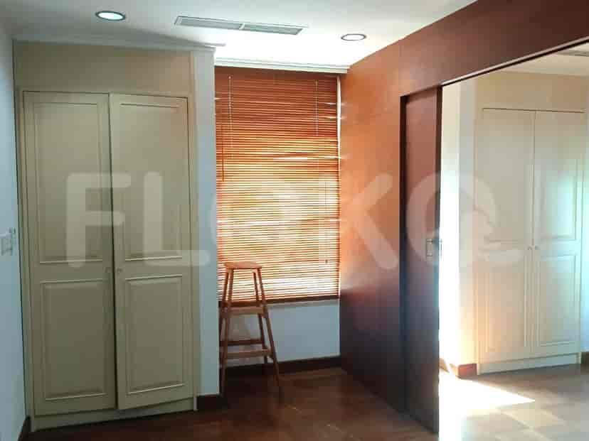 Bedroom with closets and wooden flooring.