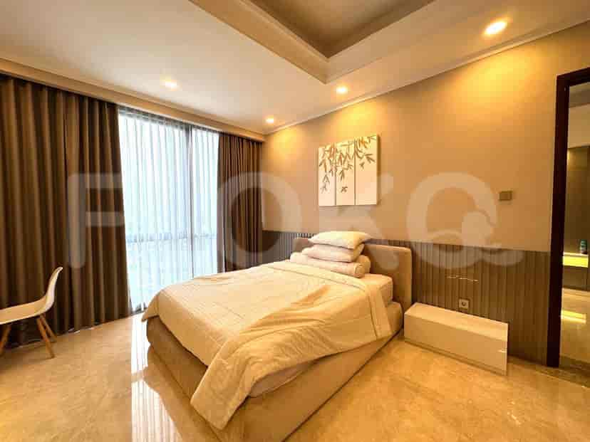 Bedroom with a bed, wall decorations, and large windows.