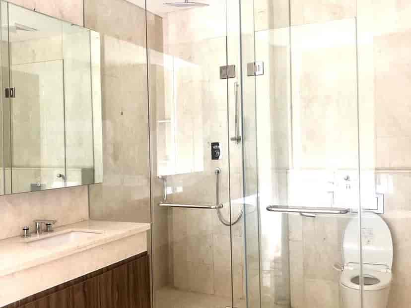 A luxurious bathroom with a glass shower enclosure and a modern toilet.