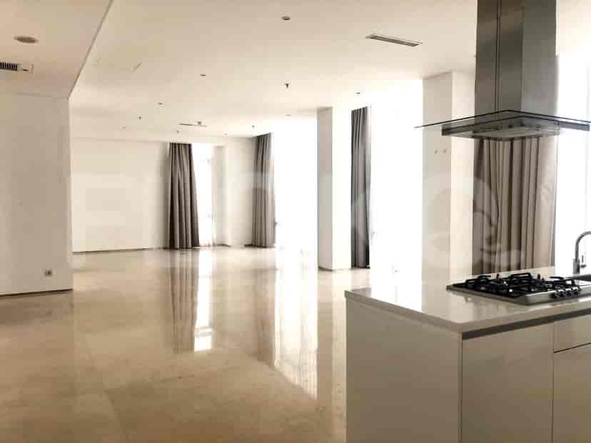 Spacious living area with white walls, marble flooring, and large windows.