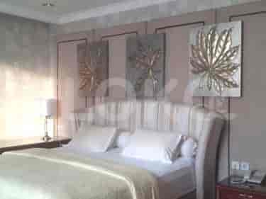 Bedroom with a bed, artwork, and a nightstand.
