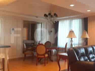 Living and dining area with a round dining table, chairs, and a leather sofa.