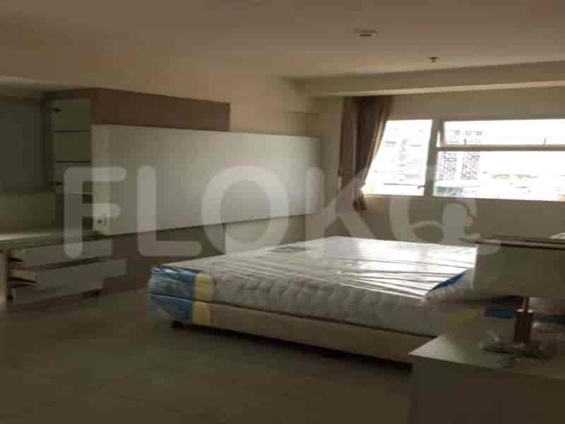 Spacious bedroom with a queen-sized bed, wardrobe, and dressing area.