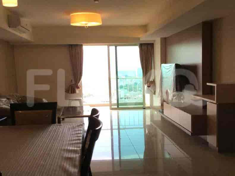 Bright living room with dining area, balcony access, and contemporary furnishings.