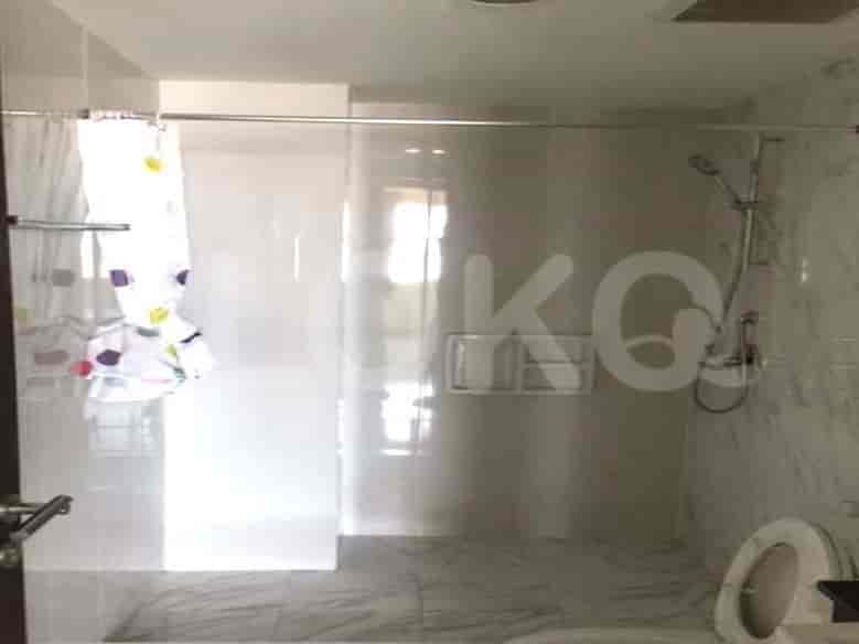 Well-lit bathroom featuring a glass-enclosed shower, toilet, and modern fixtures.