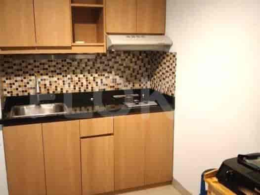 A compact and functional kitchen with wooden cabinets and a modern design.