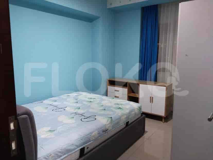 Blue bedroom with a double bed, a dresser, and a closet.