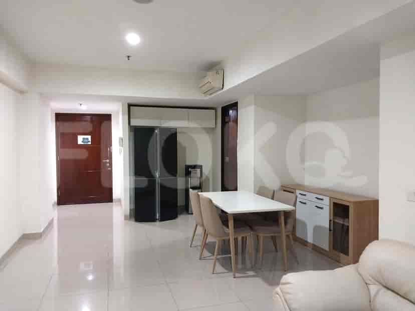 Living room and dining area combination with a dining table, chairs, and storage cabinets.