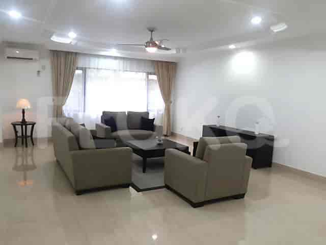 Another view of the spacious living room with a grey sofa set, and a large window.