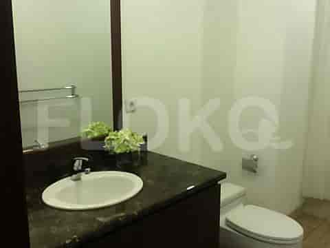 A bathroom with a sink, mirror, and toilet.