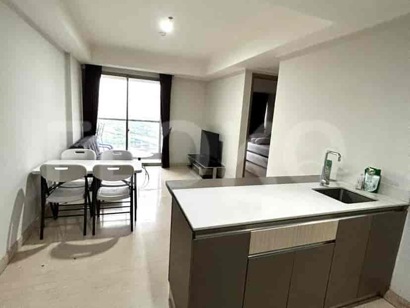 An open concept kitchen with dining table and chairs.