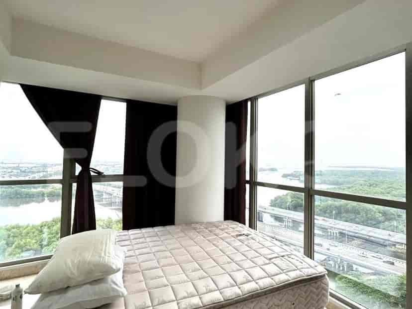 A bedroom with a bed, night curtains, and views.