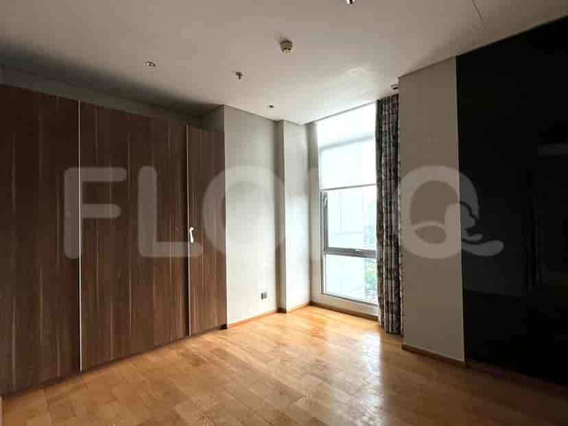 Bedroom with a closet and wooden flooring.