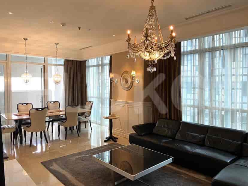 Elegant dining area with a large dining table, chairs, and chandelier.