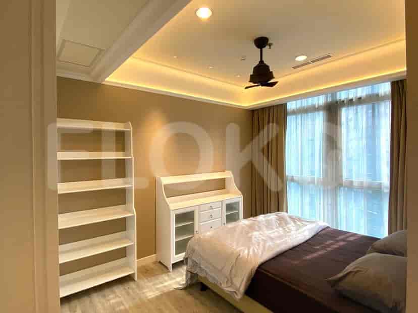 Bedroom featuring a bed, a fan, and a wardrobe.