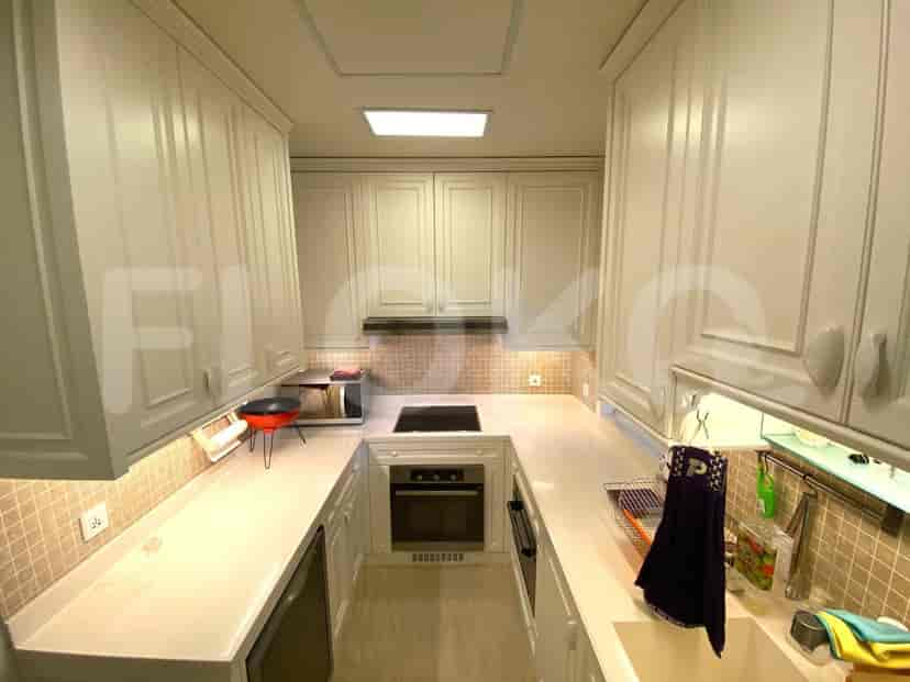 Modern kitchen with white cabinets and a light-colored countertop.