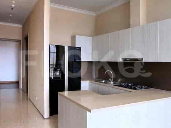 A modern kitchen with white cabinets and a black refrigerator.