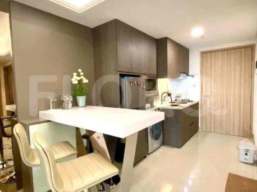 Modern kitchen featuring a breakfast bar, built-in appliances, and neutral tones.