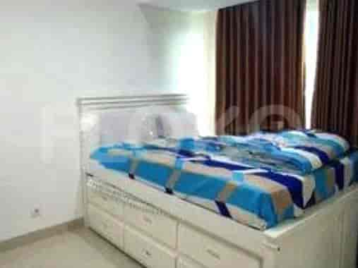 Bedroom featuring a bed with a storage base and a decorative bedspread.