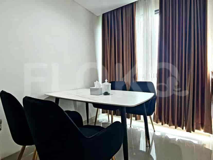Dining area with a table and four black chairs.