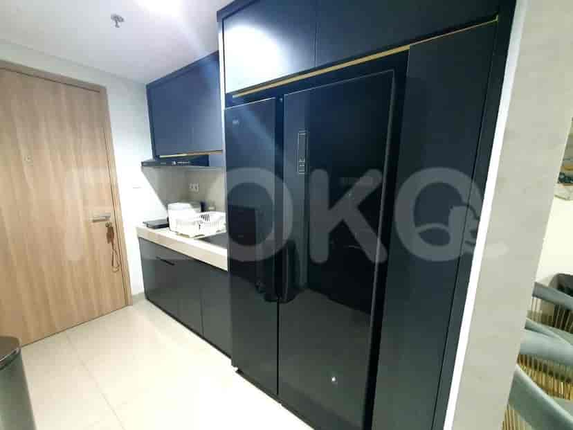 Sleek kitchen with black cabinets and modern appliances.
