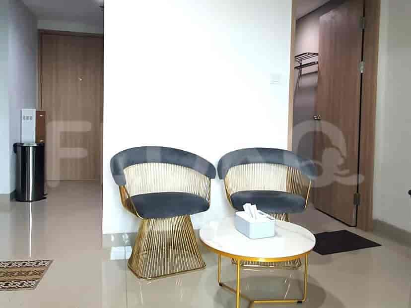 Guest seating area with two chairs and a small round table.