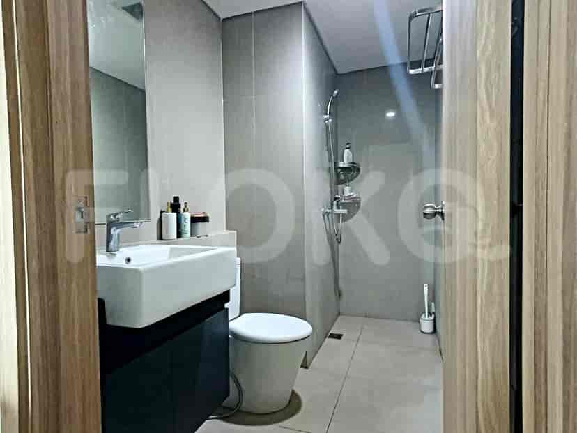 Modern bathroom with a sink, shower, and toilet.