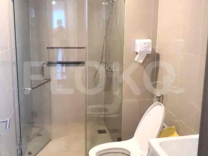 Bathroom with glass shower and toilet.