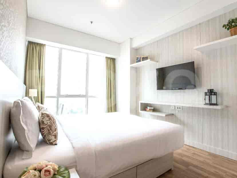A bedroom with a bed and a window.