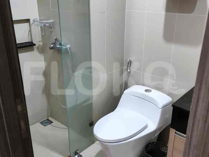 A simple, clean bathroom with a toilet and shower.