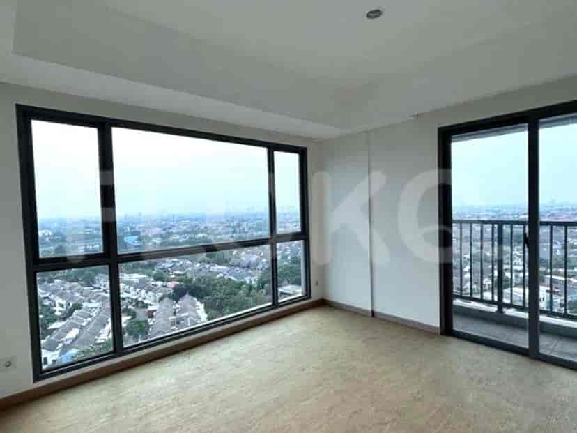 Spacious living area with large windows overlooking a city.