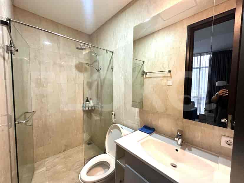 Contemporary bathroom with a glass shower, sink, and toilet.