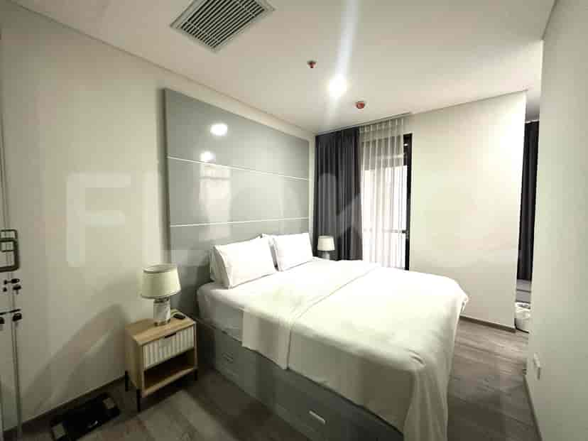 Master bedroom with a king-size bed, bedside table, and curtains.