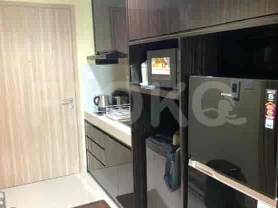 Compact kitchen with cabinets, appliances, and a sink.