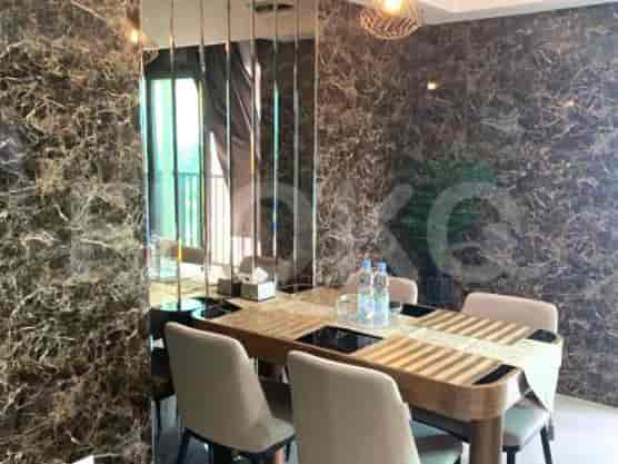 Dining area with a table, chairs, and decorative mirrors.